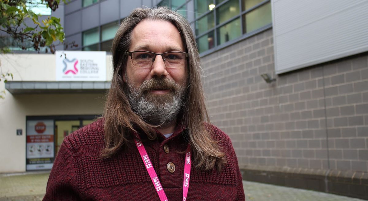 Rudi Lohe with long hair outside SERC's Lisburn Campus